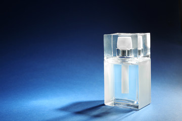 Bottle of modern male perfume on color background