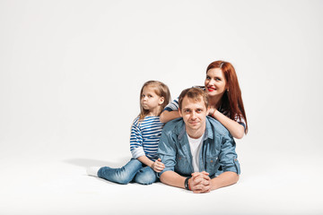 Happy funny family portrait lying on white background isolated