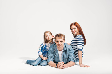 Happy funny family portrait lying on white background isolated