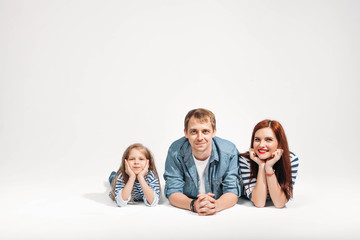 Happy funny family portrait lying on white background isolated