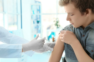 Doctor vaccinating patient in clinic