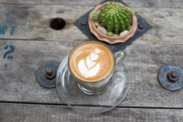 Fototapeta na wymiar Top view latte art coffee on wooden table.