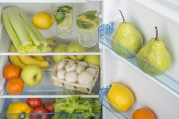 Open fridge full of fresh fruits and vegetables