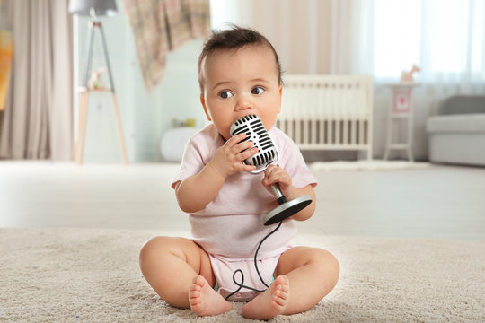 Cute Little Baby With Microphone At Home