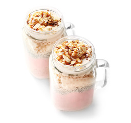 Delicious parfait with granola in jar on white background