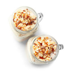 Delicious parfait with granola in jar on white background