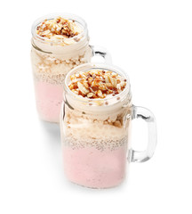 Delicious parfait with granola in jar on white background