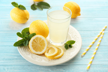 Delicious lemon juice in glass on kitchen table