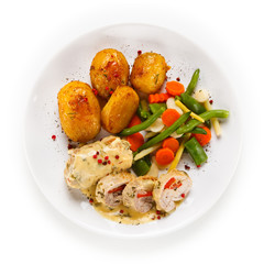 Meatballs with potatoes and vegetables on white background