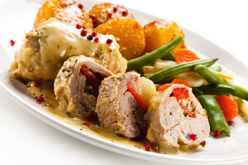 Meatballs with potatoes and vegetables on white background