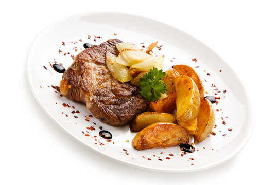 Grilled steak with french fries on white background