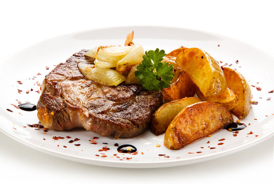 Grilled steak with french fries on white background