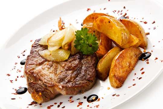 Grilled steak with french fries on white background
