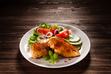 Grilled chicken fillet on wooden table