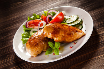 Grilled chicken fillet on wooden table