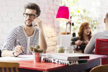 Graphic designer talking on smartphone