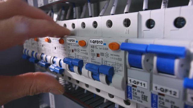 The man switching on the converters , circuit breakers. No face. Close-up. 4K.