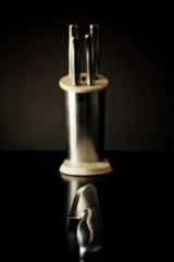 Kitchen knives set against dark brown background