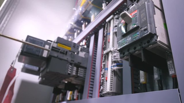 The man adjusts the power unit and swiths on the electronic system. No face. Close-up. 4K.