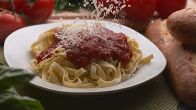 Parmesan cheese sprinkled onto pasta in super slow motion, shot on Phantom Flex 