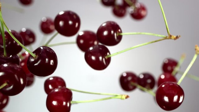 Close-up of cherry rotates in the air on a white background