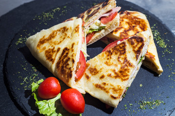 Sandwich bread, tomato, lettuce and yellow cheese. Top view of Healthy Sandwich toast with lettuce, ham, cheese and tomato on the plate.