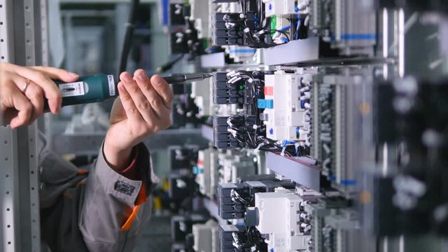 The man assembles the transformer. No face. Close-up. 4K.