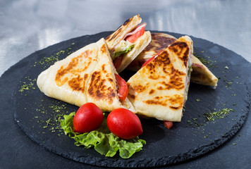 Sandwich bread, tomato, lettuce and yellow cheese. Top view of Healthy Sandwich toast with lettuce, ham, cheese and tomato on the plate.