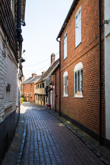Traditional brick houses in a narrow alley in Canterbury, England.