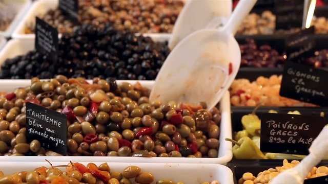 Assortment of spiced olives, vegetables and pickles on the farmers market stand in France. Regional cuisine, natural healthy food and abundance concept
