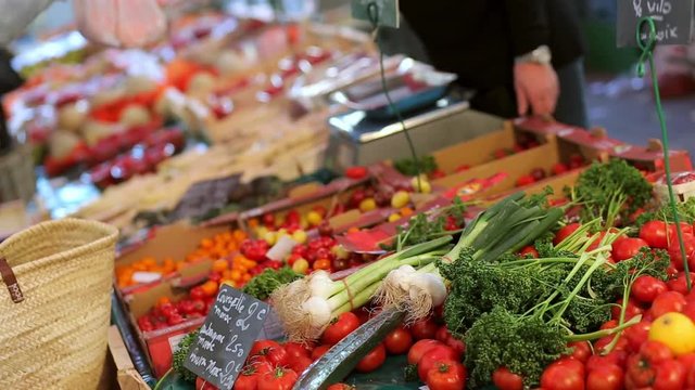 Fruits and vegetables stand at the farmers market place in Dieppe, France. Regional cuisine, natural healthy food and abundance concept. Blurred background