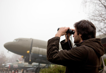 Fototapeta na wymiar Guy looking at binoculars