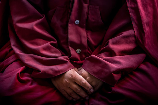 A red robed Buddhist monk in Chemrey monastery in the Indian Himalaya.