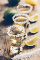 Mexican tequila with lemon on wooden table