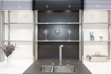 New modern black and white kitchen with chrome water tap and rectangular designer kitchen sink