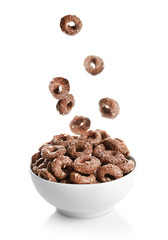 Corn rings falling into bowl on white background