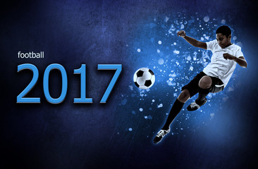 Obraz premium Text FOOTBALL 2017 and African-American youth player on dark background