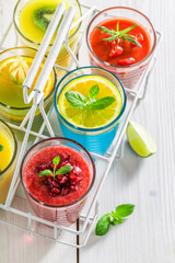 Sweet smoothie with fresh fruits on white table
