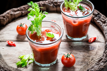 Tasty bloody mary cocktail with tomatoes and ice