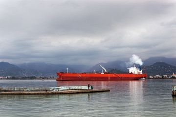 cargo ship sailing in still water near port of Batumi