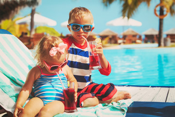 kids relax on tropical beach resort and drink juices