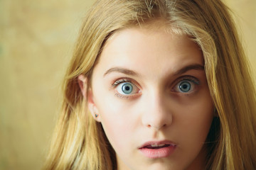 beautiful surprised girl on wall background