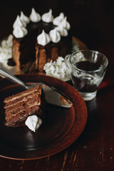 chocolate cake on a plate with glass of water