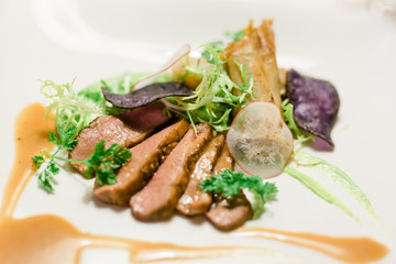 Filet of meat with field salad on plate
