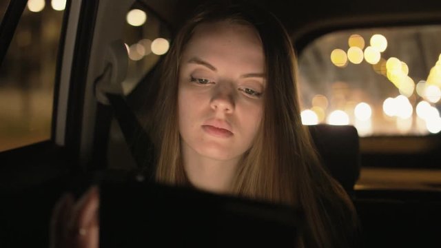 Young Businesswoman Using a Tablet Computer in the Car