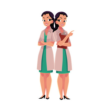 Two female, woman doctors in white medical coats, one with arms folded, another holding clipboard, cartoon vector illustration isolated on white background. Full length portrait of two female doctors