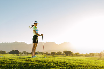 Female golfer standing on golf course
