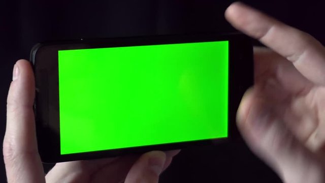 Close-up of male hands touching of smartphone. Green screen Chroma Key. Close up. Tracking motion.
