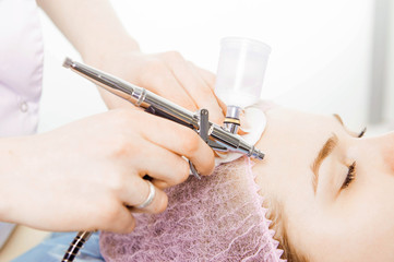 Cosmetologist performs the rejuvenation procedure