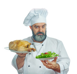  chief cook  holding  Fried chicken and vegetables.